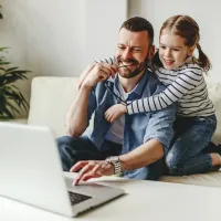 father daughter on laptop