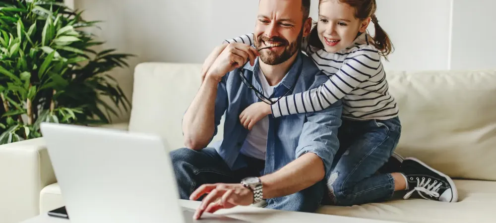 father daughter on laptop